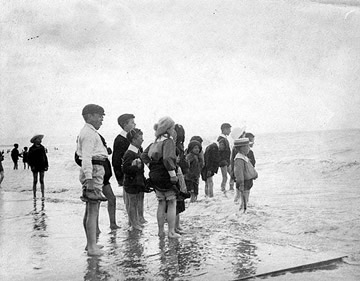 children paddling in shallow water